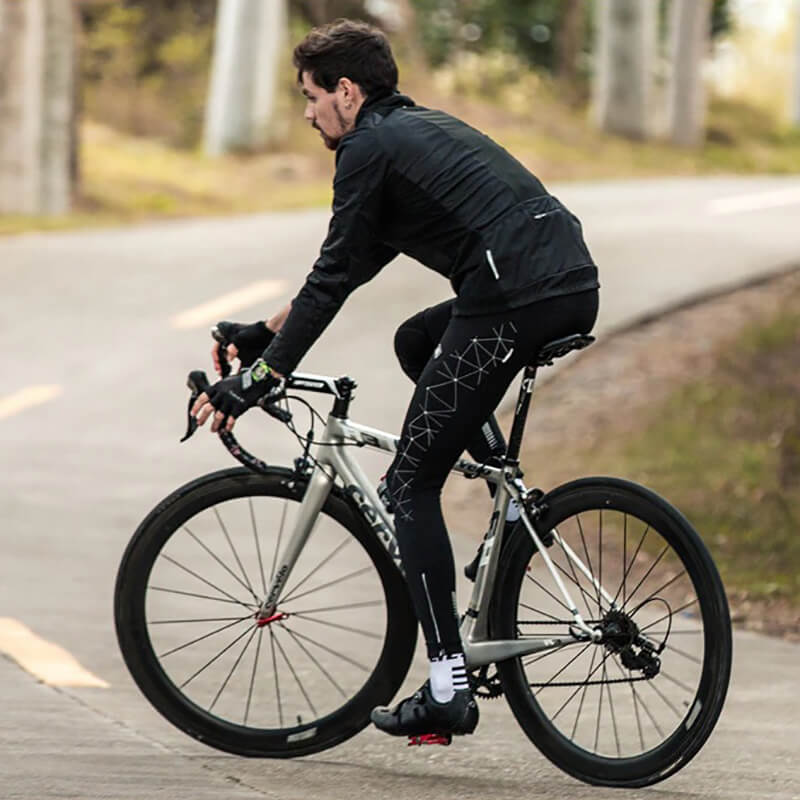 Man cycling on road wearing stylish warm bike jacket with high slit pockets on a silver road bike for men, SF0715 model.